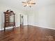 Bedroom featuring hardwood floors, neutral walls, antique cabinet and ample closet space at 214 Tenth St, Cramerton, NC 28032