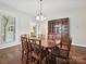 Dining room with hardwood floors, chandelier, and traditional decor. Large windows offer views at 214 Tenth St, Cramerton, NC 28032