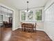 Dining area with wood floors, large windows for ample light, and view to additional dining space at 214 Tenth St, Cramerton, NC 28032