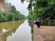 View of the C.B. Huss Fishing Pier with a river surrounded by green trees at 214 Tenth St, Cramerton, NC 28032