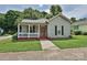 Charming home with a covered front porch, black shutters, and a well-manicured lawn at 214 Tenth St, Cramerton, NC 28032