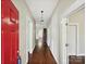 Hallway features hardwood floors, neutral walls, and white trim, with a glimpse of other rooms at 214 Tenth St, Cramerton, NC 28032