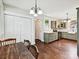 Charming eat-in kitchen with sage green cabinets, stainless appliances, hardwood floors, and closet at 214 Tenth St, Cramerton, NC 28032