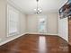Bright living room with hardwood floors, brick accent wall, and ample natural light at 214 Tenth St, Cramerton, NC 28032