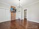 Living room with hardwood floors, built-in shelving, brick accent wall, and white trim at 214 Tenth St, Cramerton, NC 28032