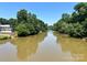 Scenic river view surrounded by lush greenery and blue skies, perfect for nature lovers and outdoor enthusiasts at 214 Tenth St, Cramerton, NC 28032