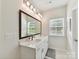 Well-lit bathroom with double sinks, a large mirror, and plenty of counter space at 2343 Mt. Harmony Church Rd, Matthews, NC 28104
