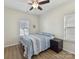 Cozy bedroom with a ceiling fan and a quilt-covered bed, illuminated by natural light at 2343 Mt. Harmony Church Rd, Matthews, NC 28104