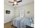 Comfortable bedroom with wood floors, ceiling fan and mounted TV screen on the wall at 2343 Mt. Harmony Church Rd, Matthews, NC 28104
