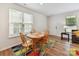 Cozy dining area featuring a wooden table and chairs with natural light from the window at 2343 Mt. Harmony Church Rd, Matthews, NC 28104