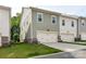 Exterior shot of a modern townhome with a two-car garage and well-maintained lawn at 2343 Mt. Harmony Church Rd, Matthews, NC 28104