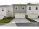 A row of townhomes with two-car garages, surrounded by green lawns at 2343 Mt. Harmony Church Rd, Matthews, NC 28104