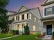A two story home with a covered porch, complemented by lush landscaping at dusk at 2343 Mt. Harmony Church Rd, Matthews, NC 28104