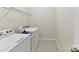 Practical laundry room featuring a washer, dryer, and wire shelving for ample storage at 2343 Mt. Harmony Church Rd, Matthews, NC 28104