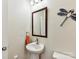 Stylish powder room with pedestal sink, decorative mirror, and modern fixtures at 2343 Mt. Harmony Church Rd, Matthews, NC 28104