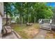Backyard featuring a deck, patio, mature trees, and a comfortable seating area, ideal for outdoor relaxation at 256 Rose St, Mooresville, NC 28117