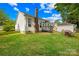 Spacious backyard view with a patio, chimney, outbuilding, and well-maintained lawn, perfect for outdoor activities at 256 Rose St, Mooresville, NC 28117