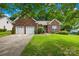 Charming brick home with a well-manicured lawn and a two-car garage at 256 Rose St, Mooresville, NC 28117