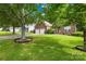 Beautiful brick home with a lush front lawn and mature trees at 256 Rose St, Mooresville, NC 28117