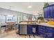 Modern kitchen with sleek stainless steel appliances, blue cabinetry, and open view to the dining area at 256 Rose St, Mooresville, NC 28117