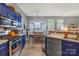 Gourmet kitchen with blue cabinets, stainless appliances, and ample counter space at 256 Rose St, Mooresville, NC 28117