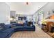 Comfortable living room with cozy fireplace, plush blue sofa, and open layout to the kitchen at 256 Rose St, Mooresville, NC 28117