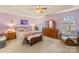 Serene main bedroom with tray ceiling, plush carpet, and elegant wooden furniture at 256 Rose St, Mooresville, NC 28117