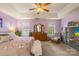 Spacious main bedroom with tray ceiling, dual windows, and comfortable seating area at 256 Rose St, Mooresville, NC 28117