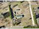 Aerial view of property with a house, outbuildings, driveway, and mature trees defining the property lines at 302 Edwards Rd, Mooresville, NC 28115