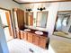 Bathroom with a dual sink vanity, large mirrors, and modern lighting fixtures at 302 Edwards Rd, Mooresville, NC 28115