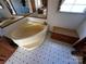 A bathroom featuring a corner tub, vanity, and a skylight providing natural light at 302 Edwards Rd, Mooresville, NC 28115