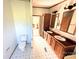 Bathroom featuring a dual sink vanity, toilet, and doorway to another room at 302 Edwards Rd, Mooresville, NC 28115