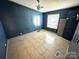 Spacious bedroom features tile floors, ceiling fan and a window providing natural light at 302 Edwards Rd, Mooresville, NC 28115