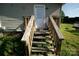 Exterior shot of stairs leading up to a door with wooden handrails at 302 Edwards Rd, Mooresville, NC 28115