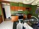 This kitchen featuring wooden cabinets, standard appliances, tile flooring and ample space for meal preparation at 302 Edwards Rd, Mooresville, NC 28115