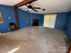 Bright living room featuring a ceiling fan, fireplace, and sliding glass doors leading to the outdoors at 302 Edwards Rd, Mooresville, NC 28115