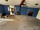 A generously sized living room featuring a fireplace, ceiling fan, and an open layout to the kitchen at 302 Edwards Rd, Mooresville, NC 28115