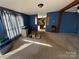 A spacious living room adjacent to the kitchen offering ample space for relaxation and entertaining at 302 Edwards Rd, Mooresville, NC 28115