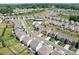Aerial view of a neighborhood featuring lush landscaping, community pool, and well-maintained homes at 3038 Burnello Ct, Iron Station, NC 28080