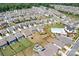 Aerial view of community with a pool, playground, and houses with well-manicured lawns at 3038 Burnello Ct, Iron Station, NC 28080