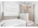 Bathroom boasts a soaking tub and a separate glass-enclosed shower at 3038 Burnello Ct, Iron Station, NC 28080