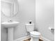 Powder room features a pedestal sink, toilet, and tile flooring at 3038 Burnello Ct, Iron Station, NC 28080