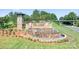 Beautiful entrance sign for 'The Farm at Ingleside' community with stone features and cascading water at 3038 Burnello Ct, Iron Station, NC 28080
