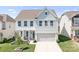 Charming two-story home with light blue siding, white trim, and a welcoming two-car garage at 3038 Burnello Ct, Iron Station, NC 28080