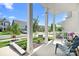 Covered front porch with chairs and a view of the quiet street at 3038 Burnello Ct, Iron Station, NC 28080