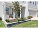 Landscaped front yard featuring a lovely tree and well-maintained stone garden bed at 3038 Burnello Ct, Iron Station, NC 28080