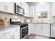 Bright kitchen features granite countertops, stainless steel appliances, and white cabinetry at 3038 Burnello Ct, Iron Station, NC 28080