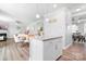 Open-concept kitchen island with granite counters overlooks the dining and living areas at 3038 Burnello Ct, Iron Station, NC 28080