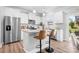 Bright eat-in kitchen featuring granite countertops, stainless steel appliances, and bar stool seating at 3038 Burnello Ct, Iron Station, NC 28080