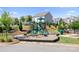 Community playground with modern play equipment, safety surfacing, and neighborhood houses nearby at 3038 Burnello Ct, Iron Station, NC 28080